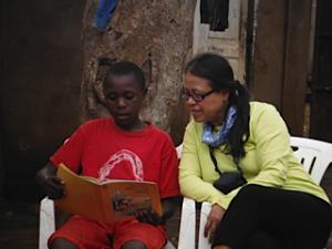 Medina helps a student with reading.